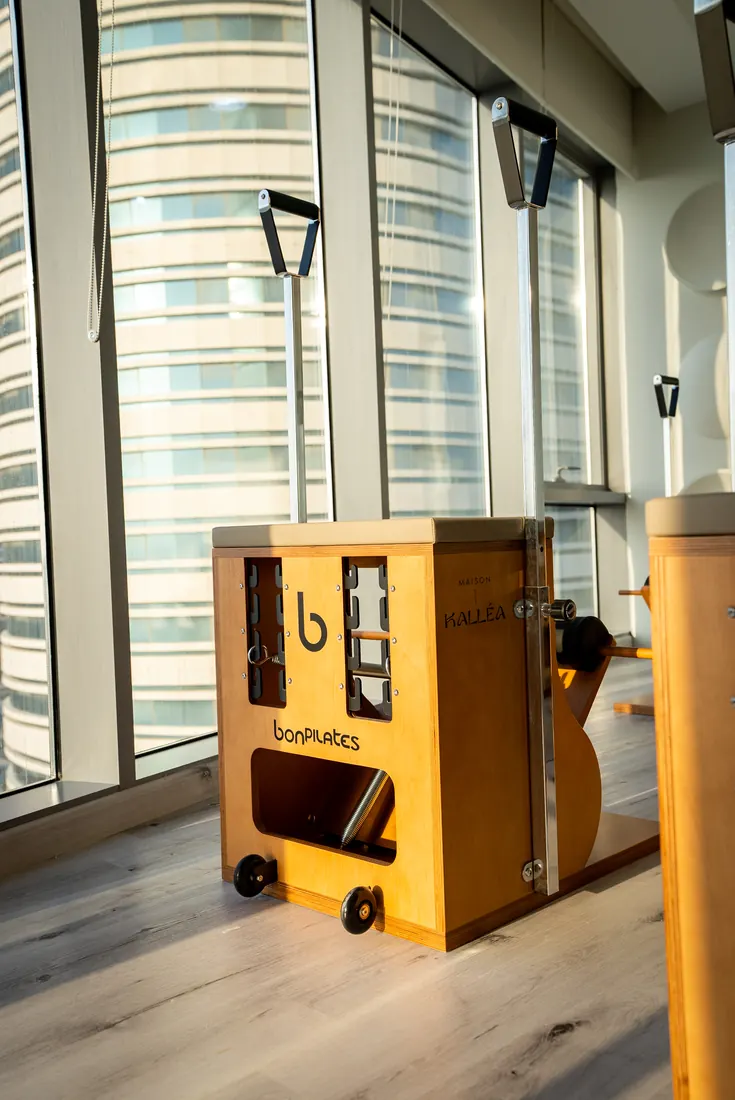 Pilates apparatus at Maison Kalléa with the Lusail skyline behind